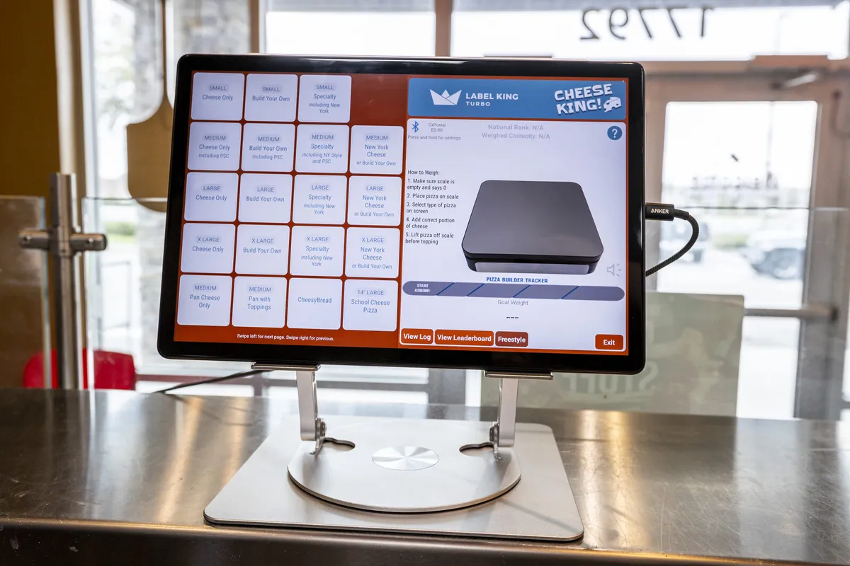 Portion King scale tablet showing the on-screen portioning menu in a pizzeria