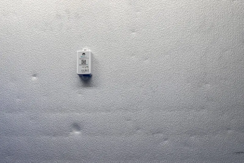 Wall-mounted Temp King wireless temperature and humidity sensor inside a walk-in cooler